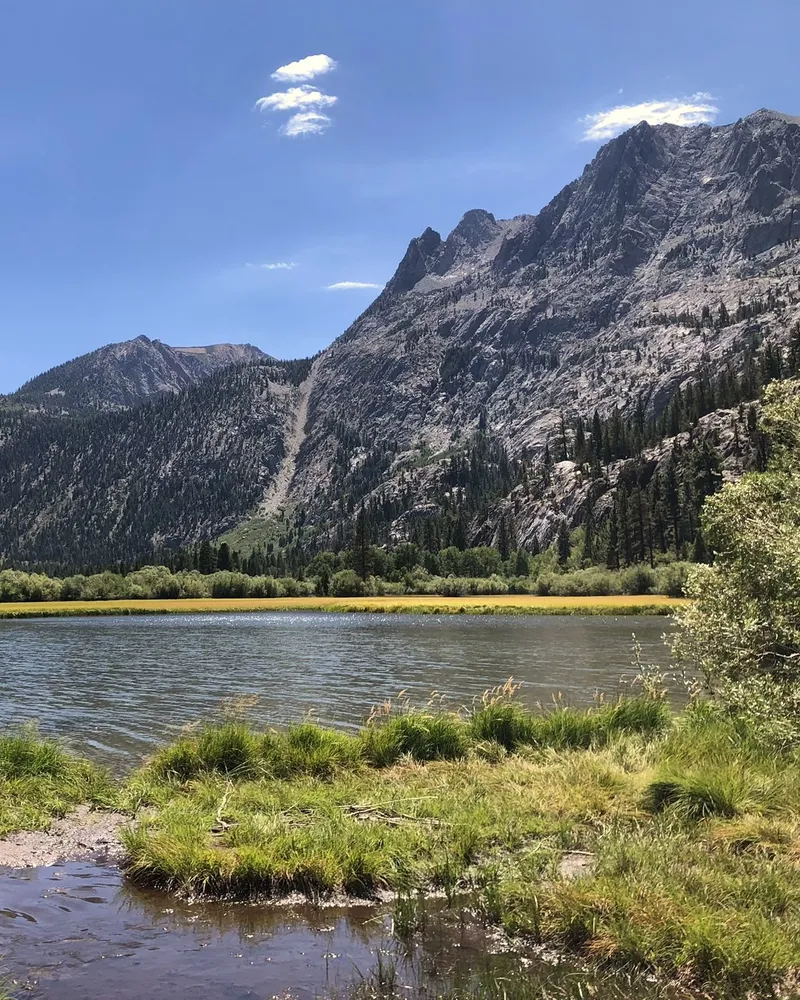 A calm mountain lake beneath granite peaks in the Eastern Sierra